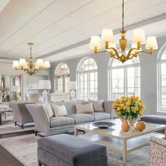 a living room filled with furniture and lots of windows