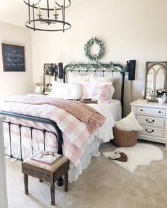 a bed room with a neatly made bed next to a dresser and mirror on the wall