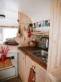 a kitchen area with sink, stove and cabinets in a mobile home or camper