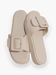 Step into style with the Bralyn Single Buckle Slide Sandal – a true showstopper that effortlessly elevates any outfit. Boasting a unique square-toe design and a striking single buckle detail, these slides are more than just footwear; they're a bold fashion statement. With a modest heel height of 0.75" and available in beige, white, or nude, the Bralyn slide adds a touch of individuality and flair to your look, making it a must-have for those who want to stand out with confidence. Features: Uniqu Toe Designs, Slide Sandals, Fashion Statement, Heel Height, Buckle, Boutique, Sandals, Heels