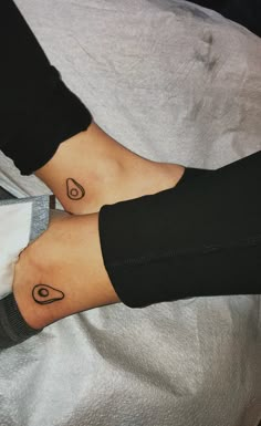 two people with matching tattoos on their feet