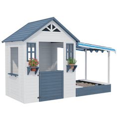 a white and blue shed with flowers in it