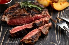 steak with herbs and sauce on wooden table