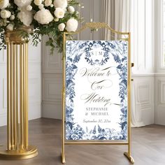 a white and blue wedding sign with flowers