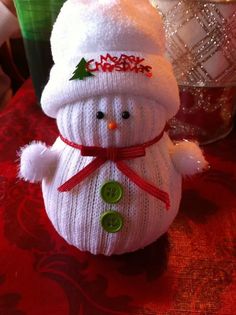 a white snowman sitting on top of a table