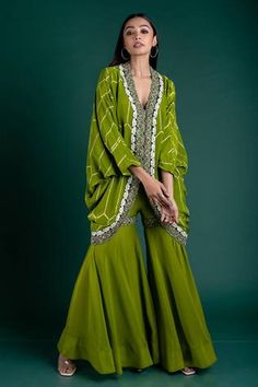 Pista green kite style tunic with bandhani details and embellished hem. Comes with gharara. Component: 2 Bandhani, Embellished Neckline: V-neck Sleeve Length: Full Fabric: Crepe Color: Green Dori, couching hand embroidered sequins on tunic hem and gharara band Hand done bandhani work Cascading round hem tunic - Aza Fashions Elegant Maternity Dresses, Diwali Outfits, Happy Dresses, Women Kurta, Fashion Design Collection, Cotton Long Dress