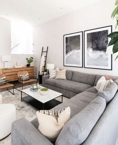 a living room filled with furniture and pictures on the wall