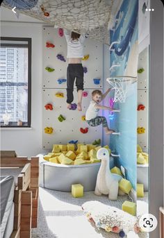 a young boy is climbing on the wall in his bedroom