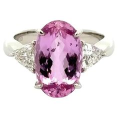 Simply Beautiful! Elegant and Finely detailed Show Stopper 3-Stone Platinum Statement Cocktail Ring. Centering a Securely nestled Hand set Long Oval Imperial Pink Topaz, weighing approx. 6.13 Carats with a Trillion Diamond on either side; weighing approx. 0.70tcw. The ring is Hand crafted in Platinum. Size 6.75, we offer ring re-sizing. Ideal worn alone or as an alternative Engagement ring. In excellent condition, recently professionally cleaned and polished. More Beautiful in real time! With its breathtaking design and superb craftsmanship, this magnificent ring is a timeless choice! Sure to be admired…illuminating your look with Timeless Beauty! Trillion Diamonds, Alternative Engagement Ring, Platinum Diamond Rings, Carpet Vintage, Pink Topaz, Alternative Engagement Rings, Platinum Ring, Cocktail Ring, Simply Beautiful