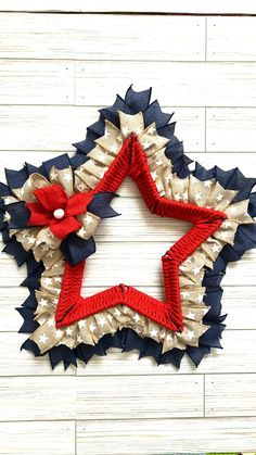 a red, white and blue star wreath hanging on a wall