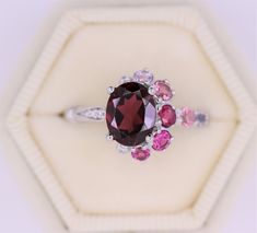 New level of the most unique 2 styles joined together Cluster+Vintage. Features a 2 carat High Quality oval shape natural Garnet. Flanked by ombre style 3 Rubellite Tourmaline and 1 Pink Tourmaline + 3 Sapphires (different shades of pink to create more ombre look), 2 VS diamonds and 3 VS diamonds in the vintage mill grain side. Set in 14k white gold. Can be custom made in rose or yellow or white gold. Please choose the gold color at checkout. All stones that I use in the creation of all my rings Elegant Cluster Rings With Gemstone Accents, Elegant Multi-stone Garnet Rings, Oval Multi-stone Garnet Rings, Asymmetric Ring, Crescent Ring, Montana Sapphire Ring, Green Sapphire Engagement Ring, Tanzanite Engagement Ring, Custom Wedding Band