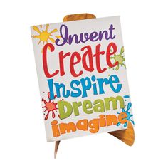 an easel with a sign that says, event create inspire dream imagine on it