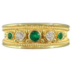 Indulge in timeless elegance with our exquisite gold ring, featuring three lustrous emeralds embraced by the subtle sparkle of two dazzling diamonds. Crafted with precision and adorned with delicate details, this ring exudes sophistication and refinement, making it a captivating addition to any jewelry collection. Each emerald and diamond is meticulously set to enhance its natural beauty, creating a piece that effortlessly captures the essence of luxury and style. 100% handmade in our workshop. Metal: 18K Gold Gemstones: Emerald weight 0,19 ct Diamond weight 0,14 ct Ring Size: 7.5 (free sizing) Discover the art of personalization as you select your dream jewelry, choosing the perfect gemstone that resonates with your unique style. Our dedicated team is always ready to assist, ensuring a se Luxury Yellow Gold Byzantine Emerald Ring, Luxury Victorian Yellow Gold Emerald Ring, Heirloom Multi-stone Emerald Ring In Gold, Antique Gold Emerald Ring With Multi-stone, 14k Gold Emerald Ring With 17 Jewels - Collectible, Byzantine Rings, Delicate Details, Emerald Diamond, Gold Diamond Rings