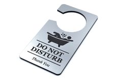 a silver bottle opener with a do not disturb sign on it