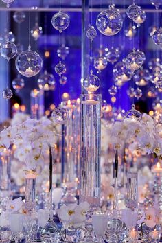 the centerpieces are filled with crystal balls and flowers