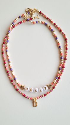 ❤️ PRODUCT DETAILS❤️ Adorn yourself in elegance with our customizable beaded necklace, featuring a vibrant mix of pink and purple beads complemented by intricate gold-plated bead details. Elevate your style or surprise a loved one with this personalized piece, designed to add a touch of sophistication to any outfit. Combination necklace in the photo:   https://www.etsy.com/listing/1539578875/custom-gold-initial-charm-necklace?click_key=9ca908a147b6ac2b551227783c627cbedee0759a%3A1539578875&click_sum=eb67b3b5&ref=shop_home_active_21&pro=1 ❤️ CARE ❤️ ❤️ Keep jewelry dry and avoid contact with water, lotions, etc ❤️ SIZE❤️ If you want a different length, write the size in the message to seller box when you check out.  Lenght: 15-16 inch/38-41 cm. ❤️ PACKAGING ❤️ ❤️ Each order comes with a love Christmas Necklace Beaded, Beaded Initial Necklace, Gold Beaded Necklaces With Letter And Round Beads, Gold Beaded Necklaces With Letter Beads, Purple Beaded Necklace With Letter Beads As Gift, Pink Gold Beads For Jewelry Making, Pink And Gold Beads For Jewelry Making, Pink Beaded Necklace With Gold Round Beads, Pink Letter Beads For Jewelry Making