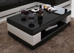 a black and white coffee table with wine glasses on it