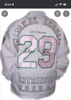 the back of a white jacket with green and pink letters on it that says,