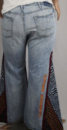 andcrafted One-Of-A-Kind LRD unisex pieces are about FIT. Offering accommodating sizes that fit male and female body frames; not about androgynous fashion that is trying to find a middle ground between both genders. These one-of-a-kind jeans are truly unique: The wide leg bell bottoms embrace a retro-inspired look that's sure to turn heads. Let the cool breeze flow with the convenience of two fully functioning side seam metal zippers. The 100% cotton African wax print fabric leg insets and ribbo Upcycled Jeans, African Wax Print Fabric, African Royalty, Upcycle Jeans, Androgynous Fashion, African Wax Print, Ankara Fabric, Female Body, Wax Print