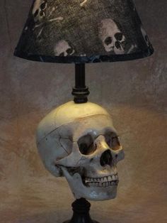 a skull lamp with a black shade on it