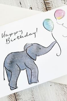 an elephant is holding balloons in its trunk and the words happy birthday written on it