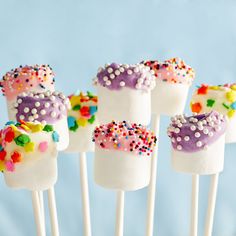 marshmallows with sprinkles are arranged on sticks