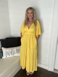 This yellow maxi dress is stunning with a flared sleeve, tiered body and open back. The material si soft and comfy as well with an elastic band at the waist. -Raglan Flare Sleeve -Ruching Tier -Maxi Dress -Open Back Side -Solid -96% Polyester, 4% Spandex -Imported. Designed by USA. Yellow Maxi Dress, Yellow Maxi, Dress With Open Back, Tiered Maxi Dress, Flared Sleeves, Elastic Band, Open Back, Maxi Dress, Spandex