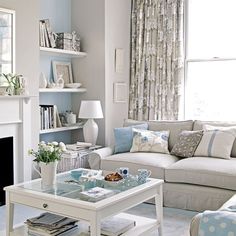 a living room filled with furniture and a fire place in front of a white fireplace