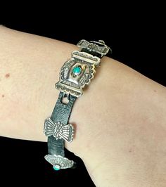 "Vintage Mini Concho Belt Bracelet. Just like a life size Concho belt, this sized down version is perfect as a bracelet. It has 9 handmade and elaborate Conchos that slide onto a black leather strap. 4 have natural Turquoise as set into sawtooth bezels. The buckle is a bit larger and rectangular shape, it clasps into a hole in the leather. The Concho's are all in very good condition and the leather is black in color. It is a wearable and great vintage piece with elaborate handmade details. It wo Concho Belt, Collector Dolls, Natural Turquoise, Life Size, Charm Bracelets, Arm Band, Turquoise Bracelet, Favorite Jewelry, Native American