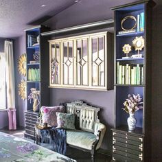 a living room with purple walls and furniture