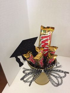 a graduation hat and some candy in a vase