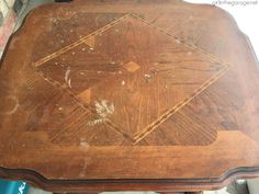 an old wooden table that has been stained brown with gold lines on the top and bottom