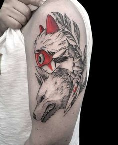 a man with a tattoo on his arm has a wolf and an arrow in it