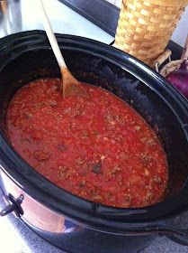 a slow cooker filled with chili and beans