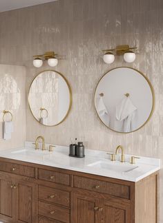 two round mirrors on the wall above double sinks in a bathroom with wood cabinets and marble counter tops