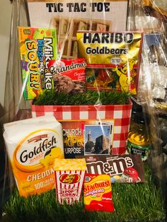 a basket filled with food sitting on top of a green grass covered floor next to a sign