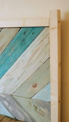 a close up of a wooden frame with paint on the side and wood planks