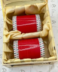 two red cups in a box on a table