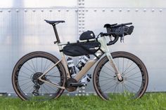 a bike parked in front of a building with a backpack on it's back