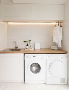 With its herringbone oak benchtop, white hexagon tiles and bagged-brick splashback, this laundry is anything but ordinary. Take a look here Laundry Room Wash Basin Ideas, White And Wood Utility Room, Laundry Room White And Wood, Laundry White And Wood, Laundry Room Ideas Medium Size, Small Utility Room Ideas With Sink, Small White Laundry Room, Small Utility Room Ideas Hanging Clothes, Small Laundry With Sink