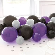 purple and white balloons are on the table