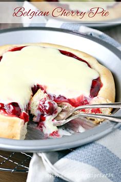 a close up of a pie on a plate with a fork and spoon in it