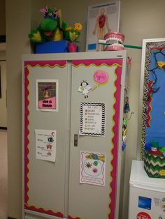 a white refrigerator freezer sitting inside of a kitchen next to a wall with pictures on it