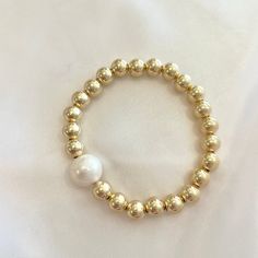 This gold ball and freshwater pearl bracelet is the perfect staple piece for your bracelet stack. Made with 18k gold filled 7mm gold balls and a 8mm freshwater pearl, this bracelet will be your perfect statement piece! Wear alone or pair with your Prata bracelet for a chunky layered look. Freshwater Pearl Bracelet, Layered Look, Staple Pieces, Bracelet Stack, Pearl Bracelet, Statement Pieces, Freshwater Pearls, Gold Filled, 18k Gold