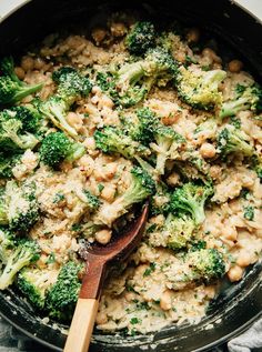 broccoli and rice in a skillet with a wooden spoon