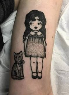 a girl with a cat on her arm and another drawing in the other side of her arm