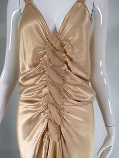 For Sale on 1stDibs - John Galliano, old Hollywood glamourous gold satin evening dress with a plunge V neckline and chiffon woven shirred center front, The back features a row Gold V-neck Evening Dress For Summer, Elegant Gold V-neck Evening Dress, Gold V-neck Evening Dress, Gold Satin Evening Dress, Glamorous Ruched V-neck Evening Dress, Gold V-neck Evening Dress For Cocktail, Gold Backless Evening Dress For Cocktail, Gold Backless Cocktail Evening Dress, Gold V-neck Satin Dress