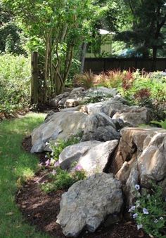 there is a rock wall in the yard