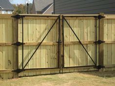 a wooden fence with metal bars on it