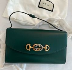 Gucci ZUMI 572375 05J0X 3154 handbag VINTAGE Mini Green Bag Leather  Gucci Zumi Shoulder Bag Mini Green Handbag Designer Bag Leather Italy New Introducing the Gucci Zumi Shoulder Bag Mini in Green—a new addition to the designer handbag collection crafted with exquisite leather in Italy. This compact and stylish accessory showcases the iconic Zumi design, named after the musician Zumi Roscow, adding a touch of modern sophistication to your ensemble. The bag features a single strap for easy carrying and boasts the interlocking silver and gold-toned GG moniker as a prominent detail against its sleek leather body. Embrace the perfect blend of fashion and functionality with the Gucci Zumi Shoulder Bag Mini, an ideal choice for those who appreciate luxury and contemporary style. Product details Designer Office Pouch Bag, Designer Pouch Flap Bag With Gold-tone Hardware, Designer Travel Flap Bag With Branded Hardware, Gucci Rectangular Satchel For Evening, Rectangular Gucci Satchel For Evening, Gucci Rectangular Evening Satchel, Designer Travel Clutch Bag, Designer Clutch Bags For Travel, Green Gucci Bag With Detachable Handle